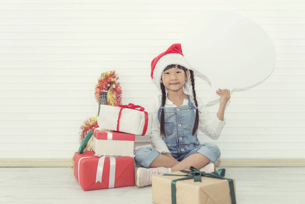 Concept portrait of children so happiness in Christmas & New Year eve with gift box & holding white board.  - Photo, Image