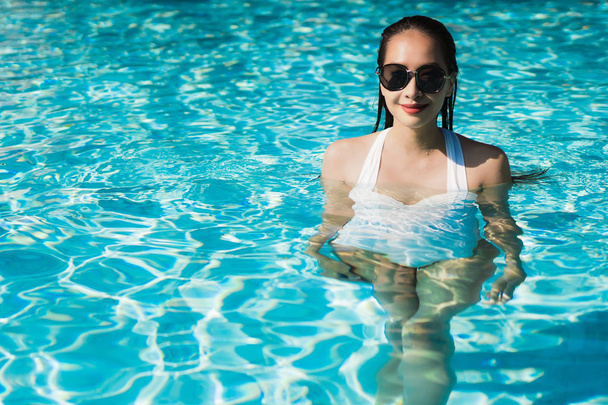 Piękna młoda kobieta azjatyckich szczęśliwy i uśmiech w basen na relaks podróży i na wakacjach koncepcja - Zdjęcie, obraz