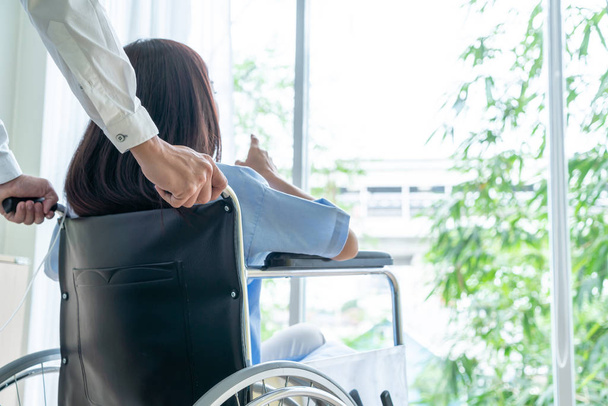 female patient on wheelchair with senior doctor - Фото, зображення