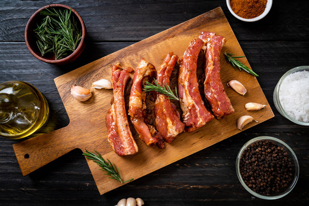 Fresh raw pork ribs ready for roasting with ingredients - 写真・画像