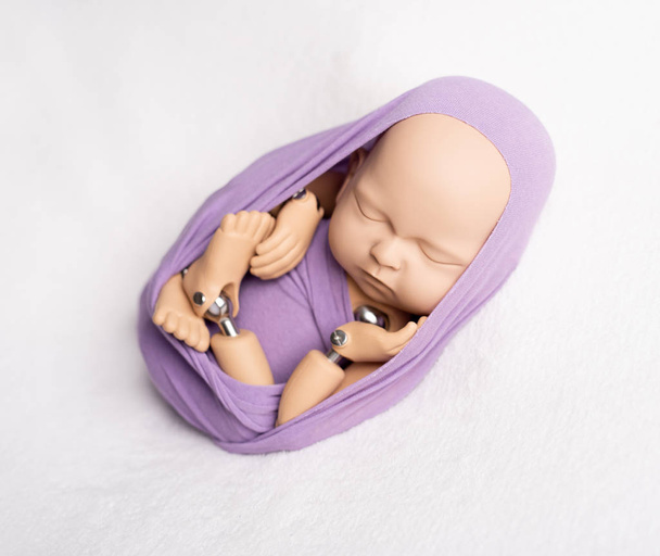 Doll of newborn kid in sling - Photo, image