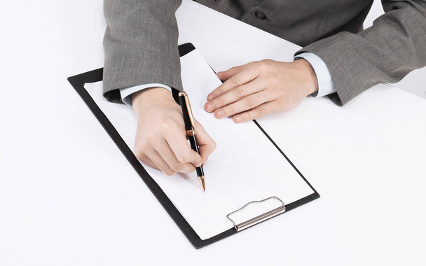 businessman reading a contract sitting behind a Desk - Фото, изображение