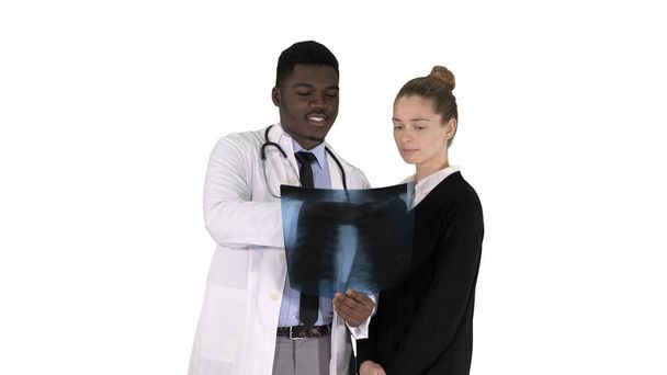 Doctor shows the patient chest x-ray on white background. - Foto, Imagen
