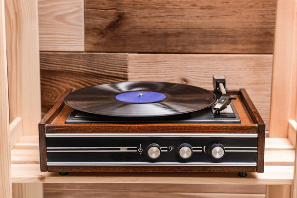 Record player with vinyl disc on wooden shelf - Photo, Image
