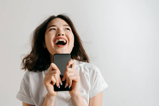 Πορτρέτο της μια κενή οθόνη δείχνει αυτοπεποίθηση casual κορίτσι της Ασίας του κινητού τηλεφώνου - Φωτογραφία, εικόνα