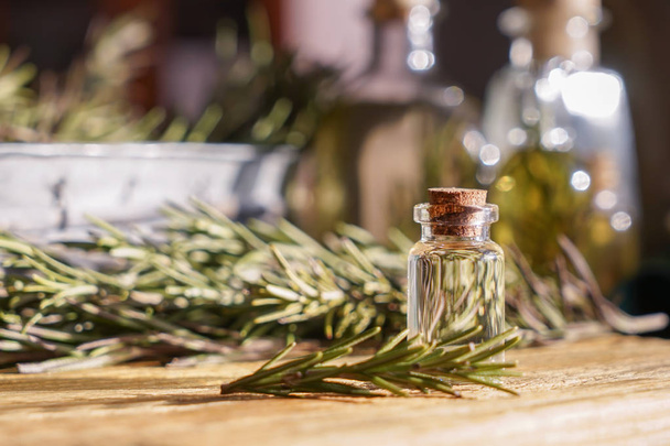 Bottle with rosemary oil on table - Photo, Image