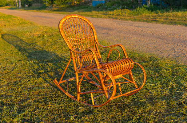 Wicker rocking-chair is waiting for the holiday-maker - Photo, Image