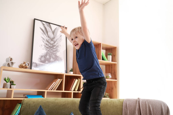 Happy little boy jumping at home - Fotó, kép