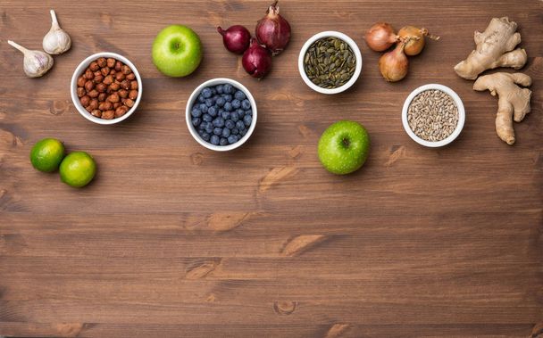 Healthy eating ingredients: fresh vegetables, fruits and superfood. Nutrition, diet, vegan food concept. Wooden background - Foto, Imagen