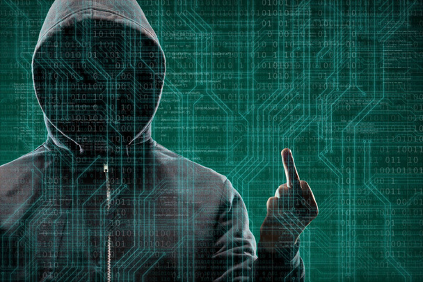 Anonymous computer hacker over abstract digital background. Obscured dark face in mask and hood. Data thief, internet attack, darknet fraud, dangerous viruses and cyber security concept. - Fotografie, Obrázek