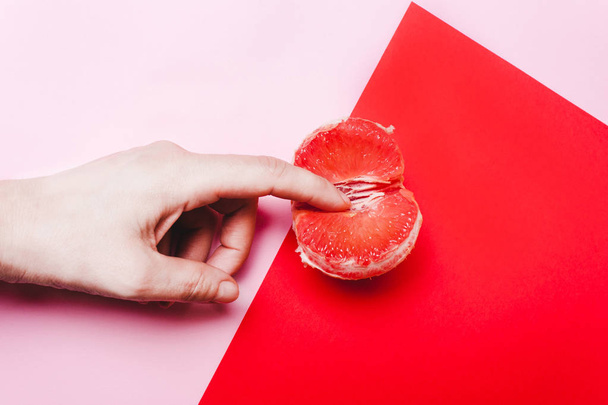 Concept sex, masturbation. Hand, fingers in grapefruit, vagina s - Photo, Image