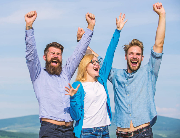 Employees enjoy feeling of freedom. Freedom concept. Company three happy colleagues office workers enjoy freedom, sky background. Men with beard in formal wear and blonde in eyeglasses finished work - Foto, Bild