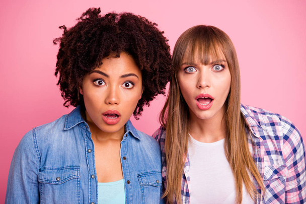 Close up photo two diversity she her ladies different race skin open mouth oh no awful situation not believe eyes wear casual jeans denim checkered shirt clothes outfit isolated pink background - Foto, Imagen