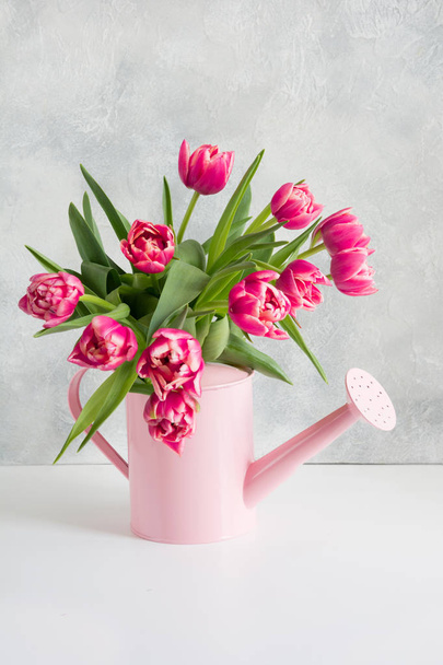 Decorative watering can with pink tulips. Gardening concept. - Foto, Imagen