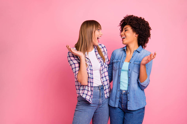 Close up side profile photo two diversity she her ladies different race good mood speak tell over news spread share news wear casual jeans denim checkered shirt cloth outfit isolated pink background - Fotografie, Obrázek