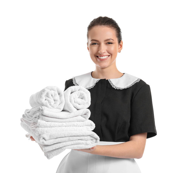 Portrait of beautiful female housekeeper with clean towels on white background - Foto, afbeelding