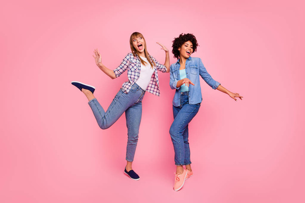 Full length body size view photo two funky diversity she her ladies dancing pop modern rhythms attend hip-hop classes wear casual jeans denim checkered shirt clothes outfit isolated pink background - Foto, afbeelding