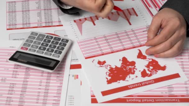 Businessman accountant using calculator for calculating finance on desk office. Business financial accounting concept. Red reports and graphs. Office employee examines schedules and reports. - Imágenes, Vídeo