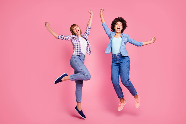 Full length body size view of two person nice-looking lovely charming cheerful cheery girls flying rejoicing isolated over pink pastel background - Foto, imagen