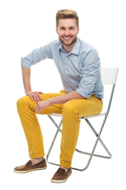 bir sandalyede oturan genç adam - Fotoğraf, Görsel