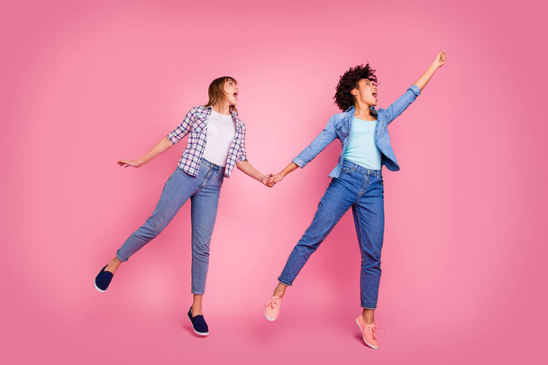 Full length body size view of two person nice lovely attractive charming cheerful cheery childish playful girls having fun hanging wind blows isolated over pink pastel background - Photo, Image