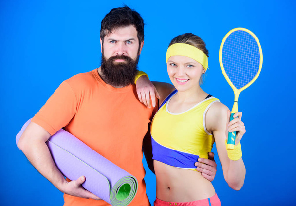 Victory and Success. Sporty couple training with fitness mat and tennis racket. Happy woman and bearded man workout in gym. Sport equipment. Strong muscles and body. ready for victory. sport success - Фото, изображение