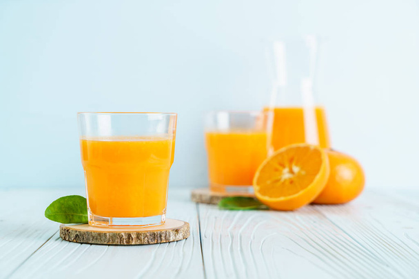 Fresh orange juice on wood background - Фото, зображення