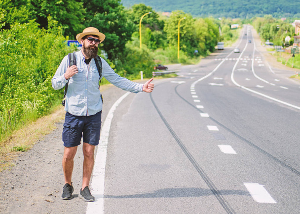 Pick me up. Hitchhiking one of cheapest ways traveling. Picking up hitchhikers. Hitchhikers risk being picked up by someone who is unsafe driver or personally dangerous. Man try stop car thumb up - 写真・画像