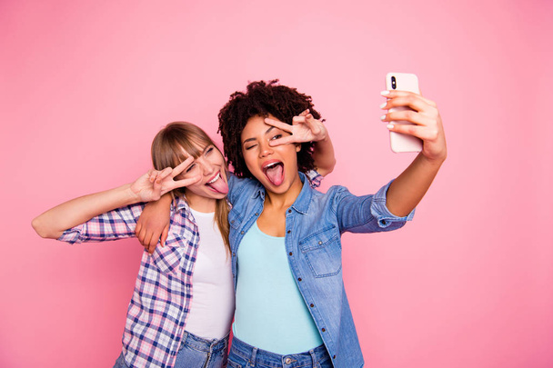 Portrait of her she two person nice cute friendly attractive charming cheerful girls wearing casual checkered shirt making taking selfie showing v-sign near eyes isolated over pink pastel background - Fotografie, Obrázek