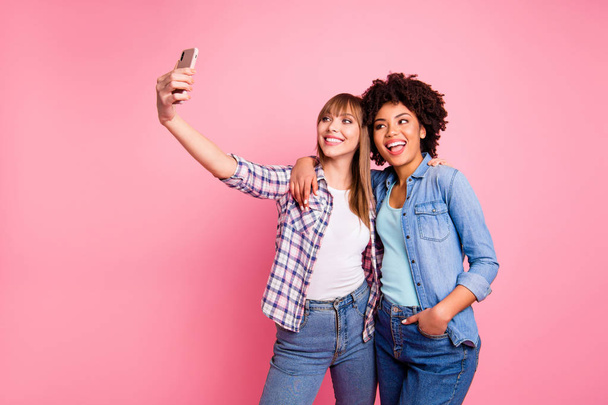 Portrait of two person nice cute lovely friendly attractive charming cheerful girls wearing casual checkered shirt making taking selfie day isolated over pink pastel background - Valokuva, kuva
