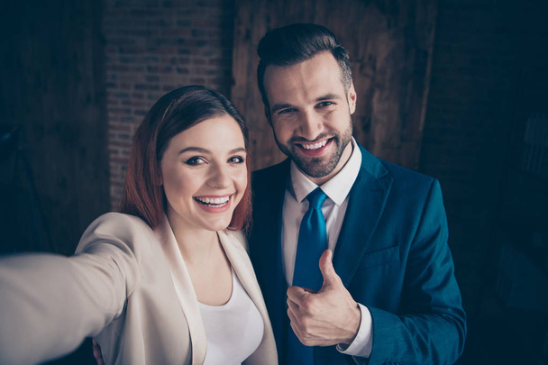 Close up photo she her business lady he him his guy buddies hands arms hold smart phone telephone make take selfies thumb up advice advertising approval tips stand office wearing formal wear suits - Foto, Imagem