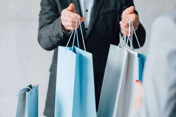 man shopping season sale consumerism bags woman - Foto, Imagen