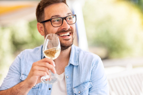 happy young man  drinking wine - Foto, Bild
