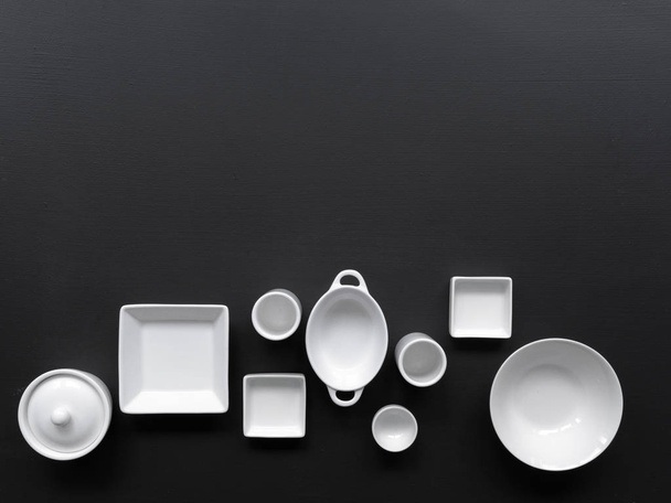 collection of white modern tableware on black background - Photo, image