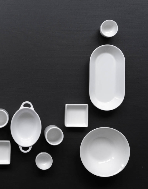 collection of white modern tableware on black background - Foto, imagen