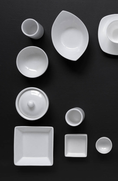 collection of white modern tableware on black background - Fotó, kép