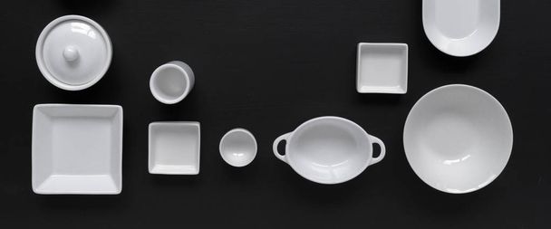 collection of white modern tableware on black background - Фото, изображение