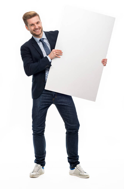 Business man holding white board - Foto, afbeelding