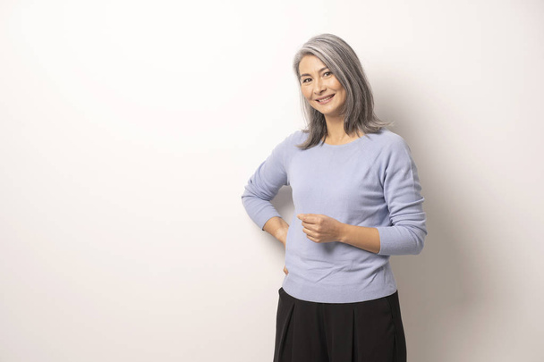 Mongolian beautiful Gray Haired Woman on a White Background. - Foto, Imagen