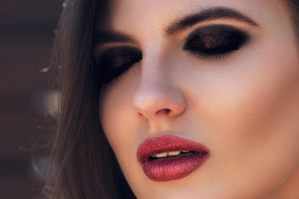Fashion woman portrait. Sensual red shiny lips. Sexy girl model with evening makeup. Romantic hairstyle.  - Zdjęcie, obraz