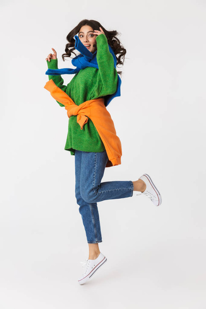 Full length image of joyous woman 30s in colorful clothes smilin - Foto, afbeelding