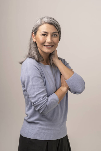 Pretty Female of Mongolian Appearance with Gray Hair on a White Background. - Fotografie, Obrázek