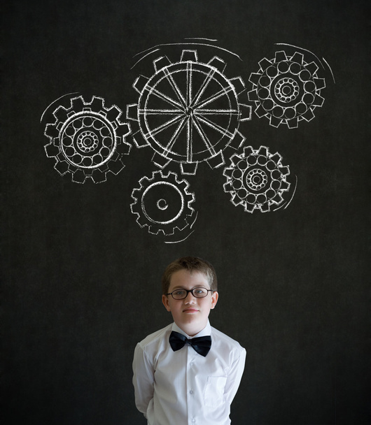 Thinking boy dressed as business man with chalk turning gear cogs or gears - Fotografie, Obrázek