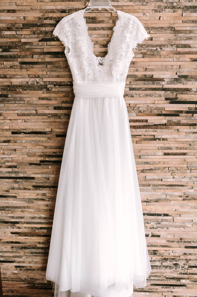 Elegant white wedding dress hanging - Photo, image