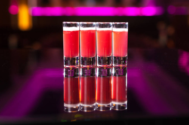 Four red cocktail shots with smoke - Photo, Image