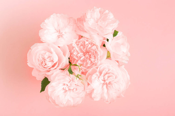 Festive flower composition on pink background. Overhead view - Fotó, kép