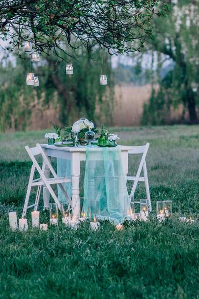 decorated table served for two in rustic outdoor. Romantic date, table setting. - Zdjęcie, obraz