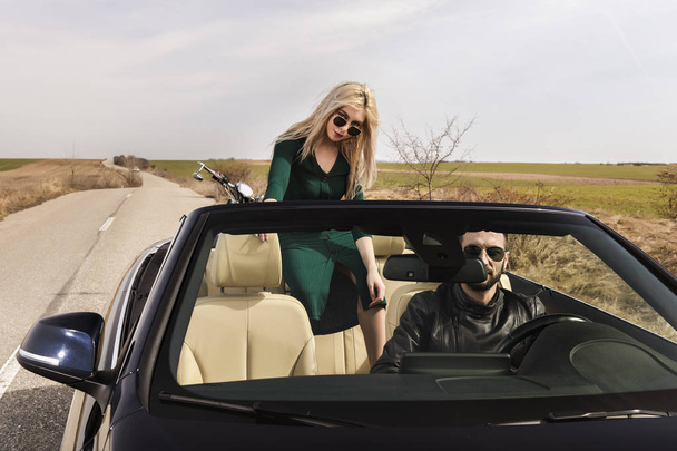 beautiful young couple traveling in a convertible - Photo, Image