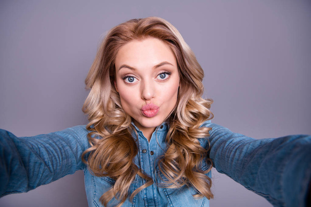 Self-portrait of her she nice cute lovely winsome charming attractive cheerful optimistic wavy-haired lady wearing blue shirt sending you hot kiss isolated over gray violet purple pastel background - Photo, image