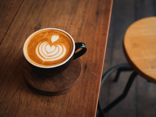 coffee latte on the wood desk in cafe - Foto, imagen